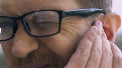 Man suffering from ear pain, bacterial infection, inflammation, otitis disease