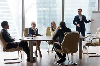 Male employee make presentation at friendly office meeting