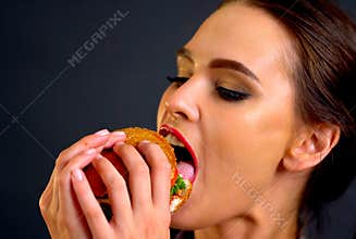 Hamburger eating contest. Woman eat with appetite .