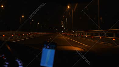 The car moves at night along the road.