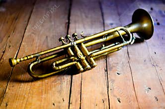 A splendid Jazz trumpet from the 1930s, on a wooden table from the 1920s