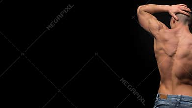 Muscular shirtless male torso isolated on black.