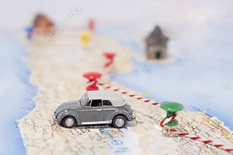 Abstract idea of rent a car. Small car on map. Abstract travel photo