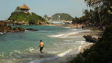 TAYRONA NATIONAL PARK, COLOMBIA - People enjoy their vacations at the sand beach of Cabo San Juan de Guía.