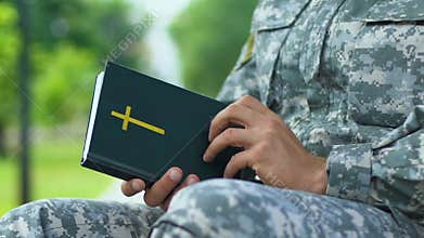 Military chaplain praying, conducting religious service to support soldiers