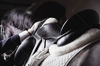 Jockey prepearing horse for the equestrian ride