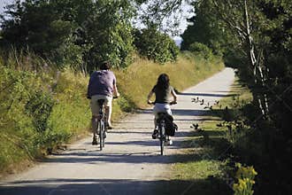 couple cycling down cycle path