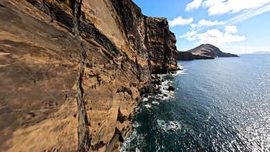 FPV racing drone Mountain surfing, and cliff diving along the rocks. Epic mountain landscape and ocean on Madeira island