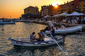 Traditional Batana boat parade at sunset in Rovinj, Croatia