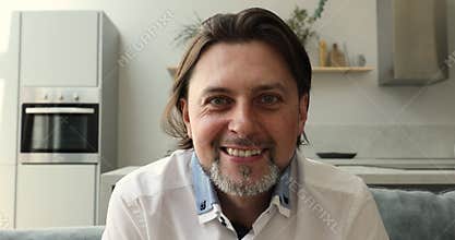 Bearded 40s man having pleasant conversation by video conference app
