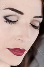 Beautiful woman eyes closed and red lips close up