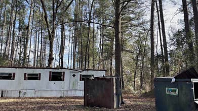 Run down trailer homes in a trailer park on Durano park trail busted windows and old dumpsters