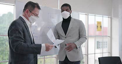 Multi-cultural businessmen collaborate and debate with someone who understands the concept of social distance and the new normal