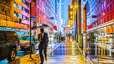 Wet colorful neon lights city street scene at night sidewalk