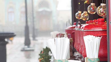 Red pots with mulled wine on Christmas market illuminated stall. Seasonal holiday street food beverages concept New year