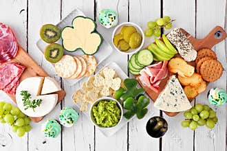 St Patricks Day charcuterie top down view table scene against white wood