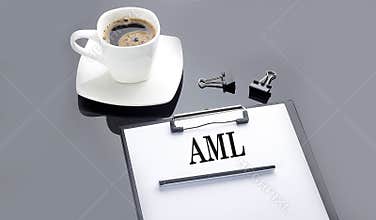 AML text on the paper sheet with coffee on the black background