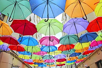 Colored umbrellas hanging at the top. Local landmark. Bold colors