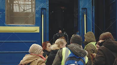 Lviv, Ukraine - March 15, 2022: Train with refugees, escorted by pro-Russian rebels, which moves between different