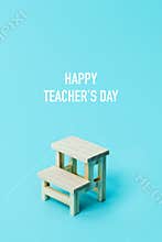 Text happy teachers day, and school desk