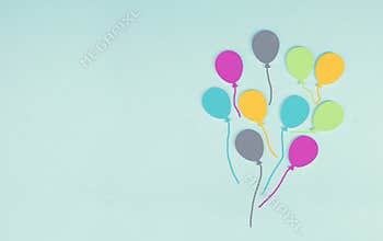 Colorful ballons on a blue colored background, children birthday greeting card, happy holiday, copy space
