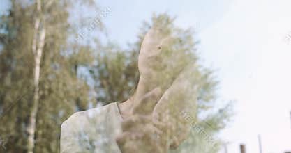 Melancholy young woman feeling stress and sadness standing by the window.