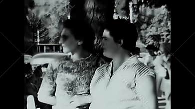 50s women talk outdoors in the city in black and white