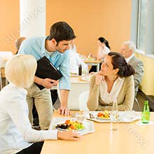 Lunch break office colleagues eat salad cafeteria