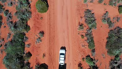 4WD vehicle towing off road caravan on a sand dirt road