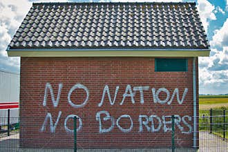 No Nation No Borders, graffiti on a brick building