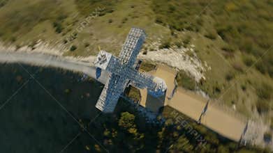 Speed flight sport FPV drone Christianity religious building white huge cross top mountain ridge