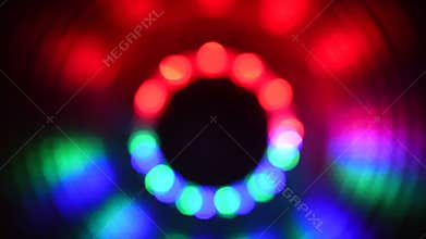 Blurry spinning red green blue lights against a black background