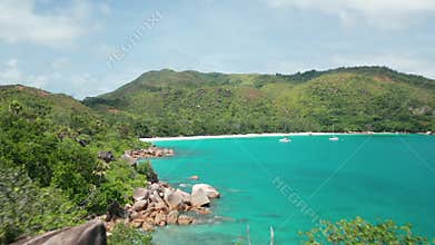Aerial dolly over coast Anse Lazio beach close up to huge boulder