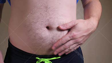 male belly closeup slow mo. Man showing beer belly