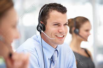 Young call centre operator helping customer