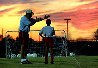 Soccer coaching at sunset