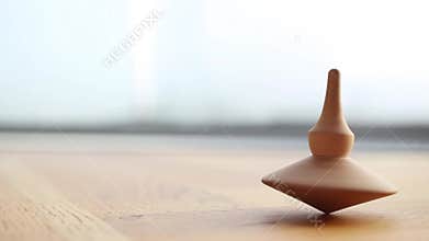 Wooden Totem spinning top coming to an end