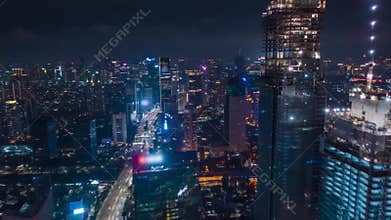 Hyper Lapse Motion Time Lapse at Night above of modern city center with skyscrapers and busy car traffic in futuristic