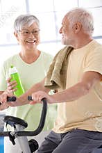 Happy elderly couple in the gym
