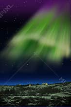 Northern Lights or Aurora Borealis and houses in Iceland