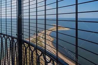 View to the Baltic sea and Sõrve peninsula through the protective grid  and railings from top of the Sõrve lighthouse