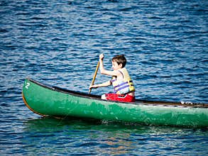 Boy Canoeing at Summer Camp