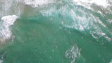 Aerial view of drone flying over ocean with waves seen
