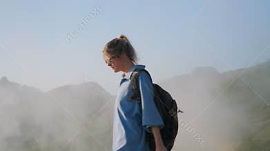 backpacking in highlands, teen girl is exploring top of mountain