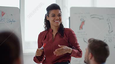 African female coach consulting audience office. Afro woman making presentation