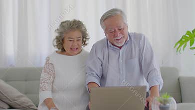 Happy Wellness Asian Elderly or Seniors couple with white hairs using computer laptop VDO Conference Call online meeting with