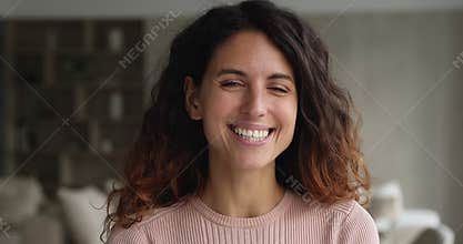 Headshot portrait gorgeous woman standing indoor smiling looking at camera