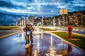 kid in a city with balance bike riding