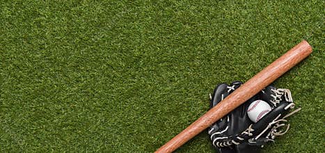 Baseball bat, glove and ball on green grass field. Sport theme background with copy space for text and advertisment