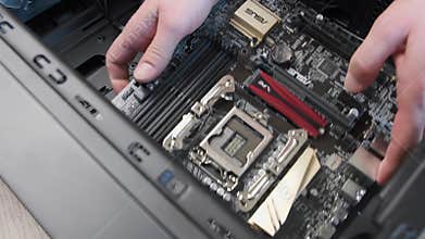 Hands place motherboard mini-ITX into PC tower for mining and gaming